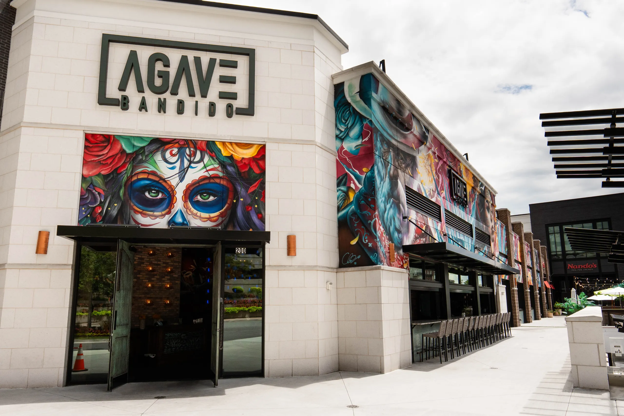 The Agave Bandido storefront, painted with Día de Muertos murals