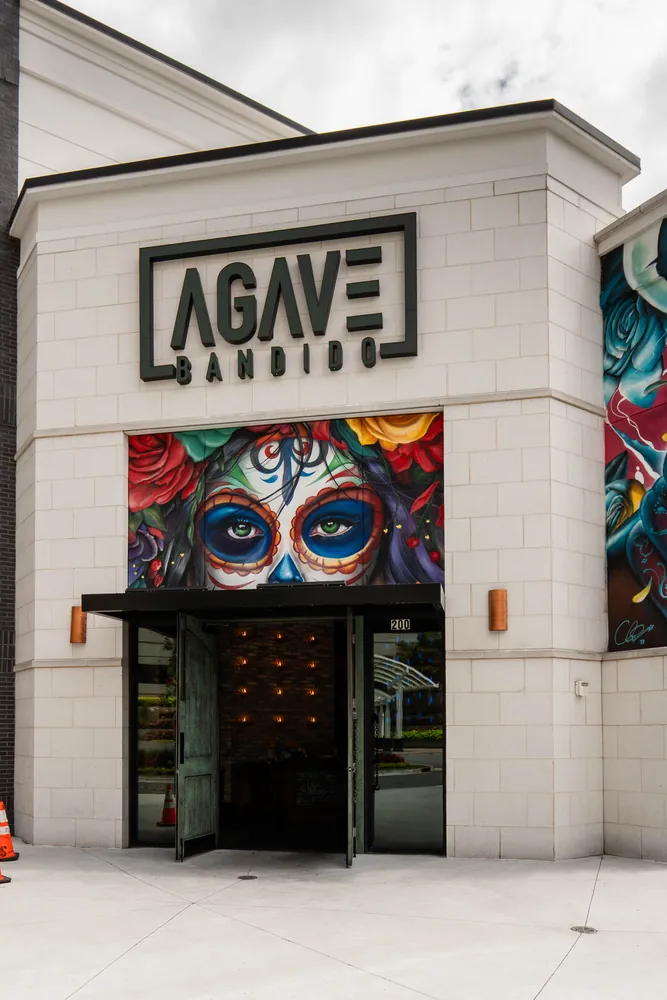 The Agave Bandido storefront, painted with Día de Muertos murals
