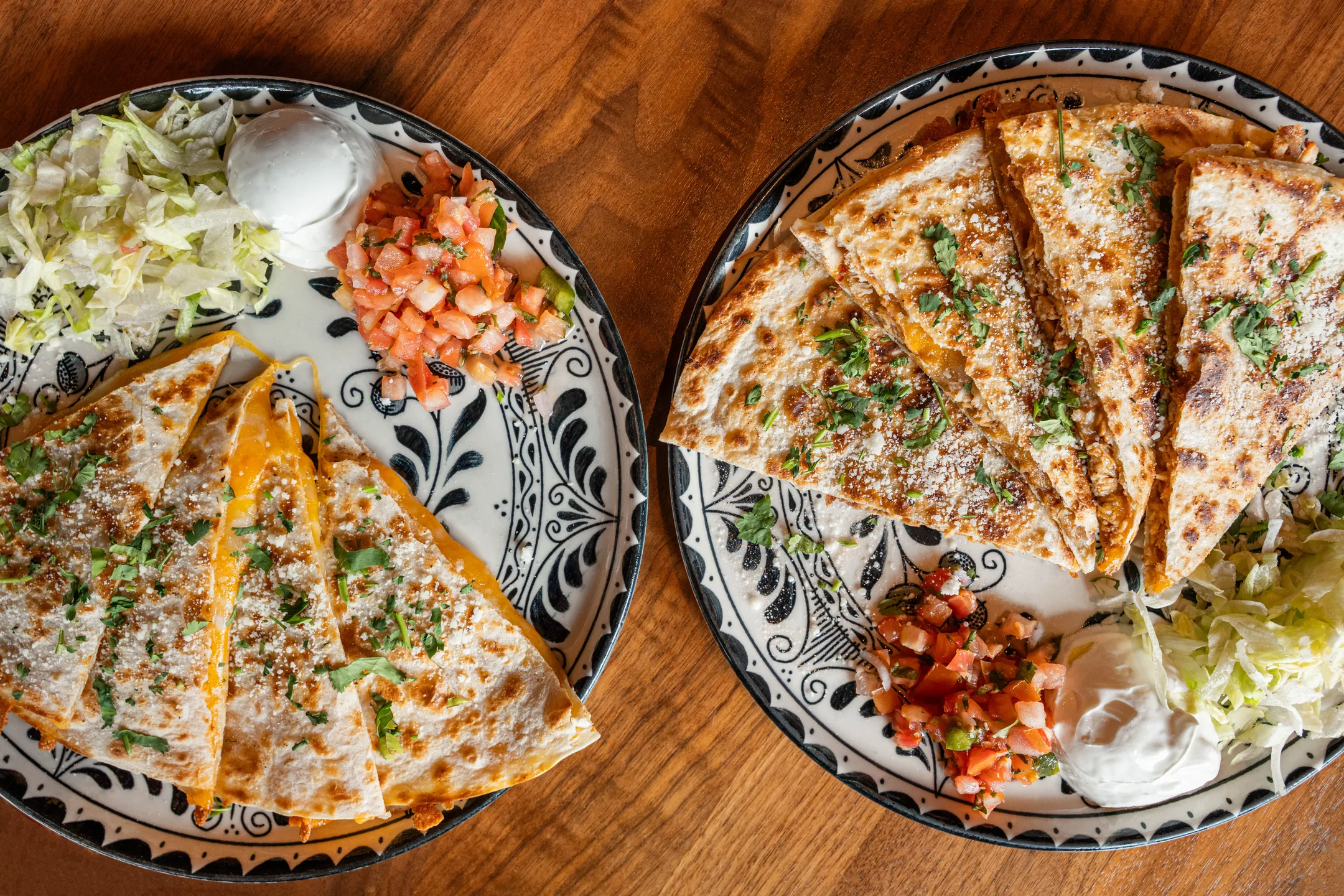 Two quesadillas served on hand-painted Talavera plates