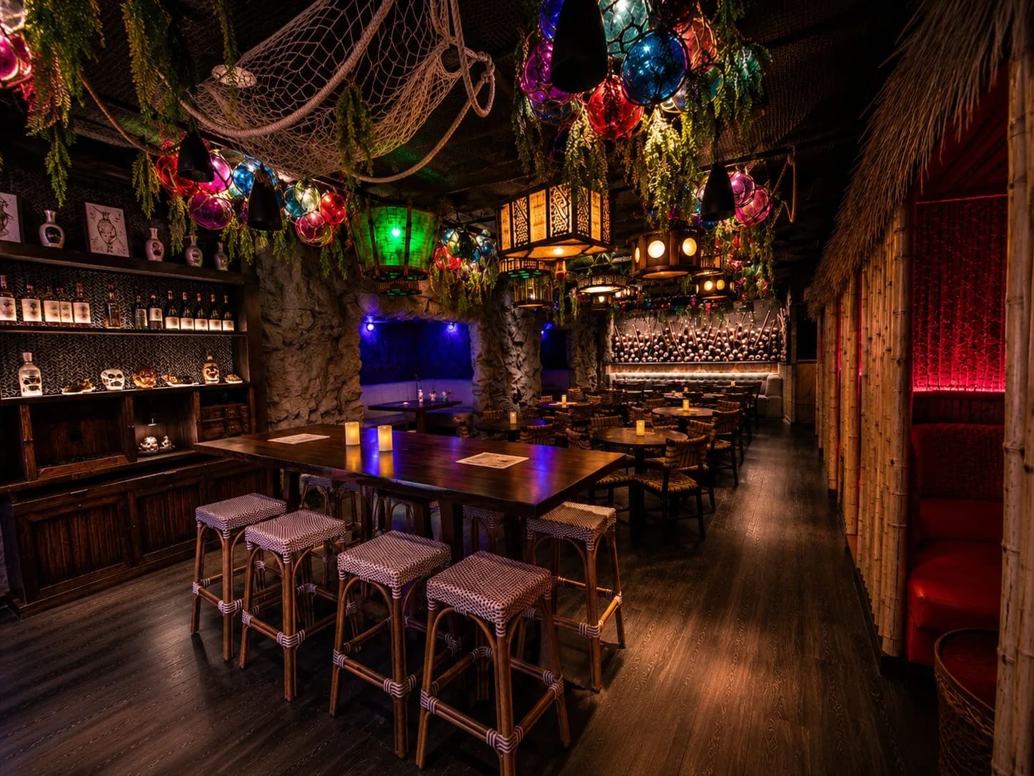 The communal table under the glass float lanterns at Maya
